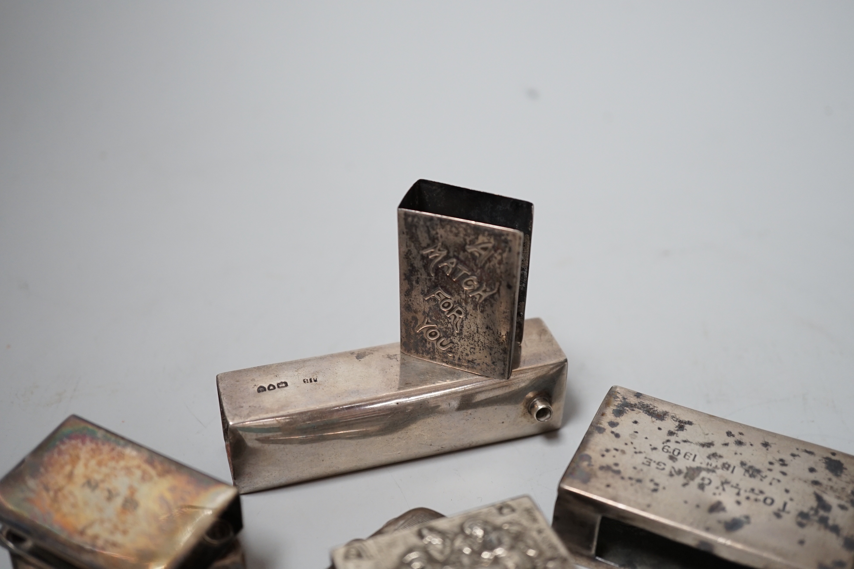 Five assorted mainly early 20th century silver matchbox sleeves and two other items including a matchbook case.
